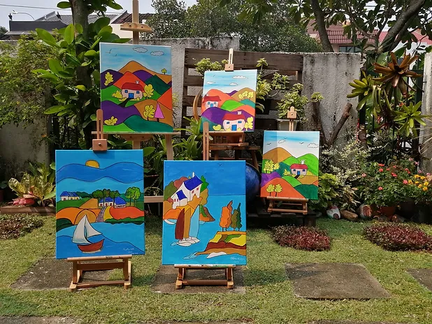 Colorful painted canvases displayed on easels in a lush green garden, bright blue and multicolor tones, cheerful artistic atmosphere
